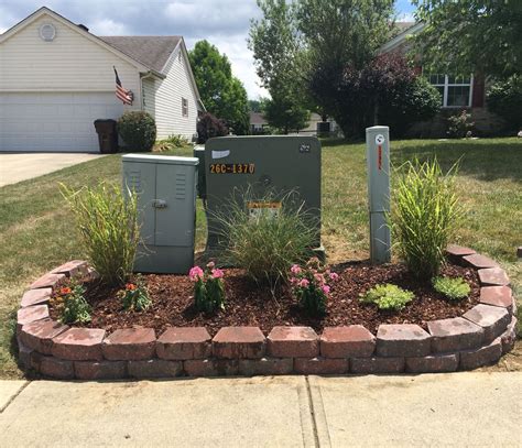 big green electrical box in front yard|landscape around electrical transformer boxes.